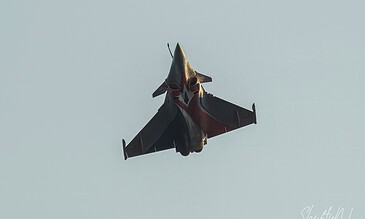 Supersonic fighter jet soaring through the sky during an airshow, showcasing sleek design and powerful aerodynamics.