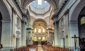 A stunning view of a historic church’s interior with grand arches, intricate moldings, stained glass windows, and religious sculptures, perfect for capturing spiritual and architectural beauty. Elegant interior of a historic church showcasing high vaulted ceilings, ornate architectural details, colorful stained glass windows, and religious icons, capturing a serene and majestic atmosphere.