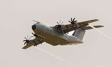 Luftwaffe A400M showing off its agility. German Air Force Airbus A400M Atlas 54+18 banking with vapour trails from the wingtips at the Leaseweb Texel Airshow, Texel International Airport, the Netherlands, August 2018.