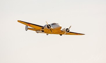 Classic Beech 18 in Dutch colours. Beechcraft 18 in historic Royal Netherlands Air Force colours flying past at the Leaseweb Texel Airshow, Texel International Airport, the Netherlands, August 2018.