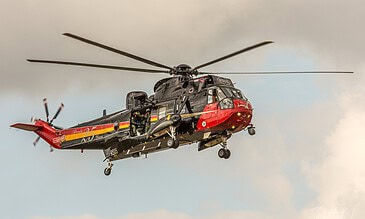 The Belgian Sea King showing off its colours. Belgian Air Force Westland Sea King search and rescue helicopter in black, yellow and red tail colours, hovering at the Belgian Air Force Days, Kleine-Brogel Air Base, Belgium, September 2018.