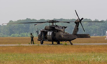 Swedish Air Force HKP 16 Black Hawk 15 on the ground with a crew member standing next to it during the APROC 2018 personnel recovery exercise at Gilze-Rijen Air Base, the Netherlands, June 2018.