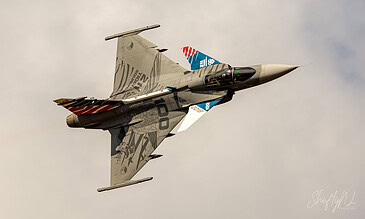 Czech Gripen 9241 in full tiger stripes. Czech Air Force Saab JAS 39C Gripen 9241 in its striking NATO Tiger Meet 2018 tiger livery, banking overhead at the Belgian Air Force Days, Kleine-Brogel Air Base, Belgium, September 2018.