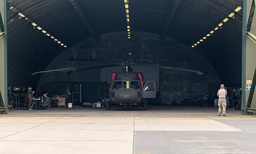 Swedish Air Force HKP 16 Black Hawk number 15 parked in a hardened aircraft shelter with its crew during the APROC 2018 personnel recovery exercise at Gilze-Rijen Air Base, the Netherlands, June 2018.