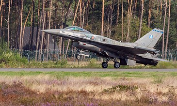 Greek F-16 lifting off. Hellenic Air Force F-16 lifting off from the runway with pine trees and heather in the background at the Belgian Air Force Days, Kleine-Brogel Air Base, Belgium, September 2018.