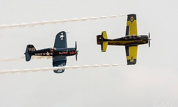 Flying Bulls Corsair and Trojan in formation. Flying Bulls F4U-4 Corsair and T-28B Trojan flying in formation with smoke at the Leaseweb Texel Airshow, Texel International Airport, the Netherlands, August 2018.