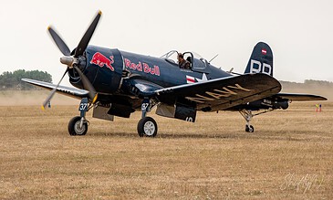 Flying Bulls Corsair taxiing in. Flying Bulls Vought F4U-4 Corsair OE-EAS taxiing on the grass at the Leaseweb Texel Airshow, Texel International Airport, the Netherlands, August 2018.