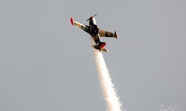 SF.260 going vertical. SIAI-Marchetti SF.260 in Belgian camouflage climbing vertically with smoke on at the Leaseweb Texel Airshow, Texel International Airport, the Netherlands, August 2018.