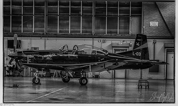 Black and white view of the hangar with Pilatus PC-7 trainers at Woensdrecht Air Base, the Netherlands, during a visit to 131 EMVO Squadron, May 2017.