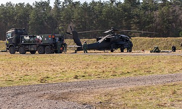 AH-64D Apaches of 301 Squadron "Redskins", Royal Netherlands Air Force and support vehicles set up in the field near the forest at the Bergen (Osterheide) shooting range, Germany, March 2017.