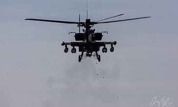 A AH-64D Apache of 301 Squadron "Redskins", Royal Netherlands Air Force in flight with its stub wings loaded and firing it's canon at the Bergen (Osterheide) shooting range, Germany, March 2017.