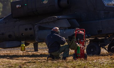 Ground crew working next to an AH-64D Apache of 301 Squadron "Redskins", Royal Netherlands Air Force on the field at the Bergen (Osterheide) shooting range, Germany, March 2017.