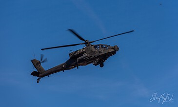 AH-64D Apache of 301 Squadron "Redskins", Royal Netherlands Air Force, flying against a deep blue sky at the Bergen (Osterheide) shooting range, Germany, March 2017.