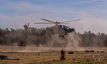 AH-64D Apache of 301 Squadron "Redskins", Royal Netherlands Air Force, flying low over the sandy range, kicking up dust at the Bergen (Osterheide) shooting range, Germany, March 2017.
