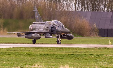 French Air Force Mirage 2000D taxiing with spring trees behind during the Frisian Flag 2018 exercise at Leeuwarden Air Base, the Netherlands, April 2018.