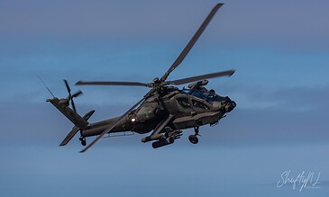 AH-64D Apache of 301 Squadron "Redskins", Royal Netherlands Air Force, tilting in a turn with its rotor blades sharply angled at the Bergen (Osterheide) shooting range, Germany, March 2017.