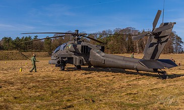 AH-64D Apache of 301 Squadron "Redskins", Royal Netherlands Air Force, on the ground with its rotors turning under a blue sky at the Bergen (Osterheide) shooting range, Germany, March 2017.