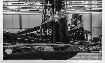 Black and white detail of the tail of Pilatus PC-7 L-13 inside the hangar at Woensdrecht Air Base, the Netherlands, during a visit to 131 EMVO Squadron, May 2017.