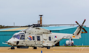 NH90 helicopter near the control tower on the platform at Naval Air Station De Kooy, the Netherlands, during a visit to 860 Squadron, October 2017.