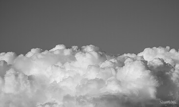 Beautiful black and white cloudscape showcasing soft textures and dramatic contrasts in the sky. Vast fluffy white clouds in a clear sky, capturing serene and majestic natural scenery for captivating photography.