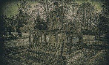 Ancient cemetery tombstone with surrounding wrought iron fence, shadowed trees, and overcast sky, captured in moody, vintage style, emphasizing historic memorials and serene graveyard atmosphere.