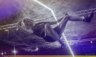 Vibrant aerial dance performance with dynamic lighting and energetic movement captured in a professional photoshoot.