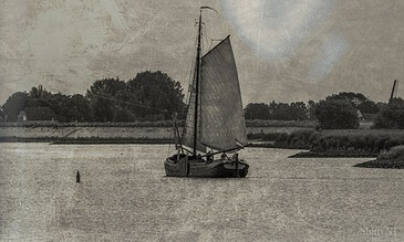 A vintage-style sailboat on calm water, captured with a textured, nostalgic effect, highlighting serene maritime moments.