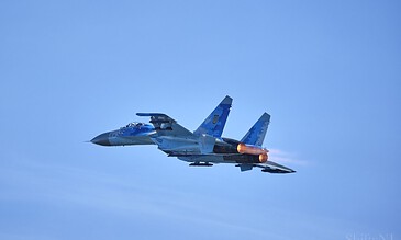 2. A powerful fighter jet with glowing afterburners soaring in the sky, capturing the thrill of modern aerial combat and aviation excellence. 1. Military fighter jet with afterburners engaged flying through a clear blue sky, showcasing advanced aviation technology.