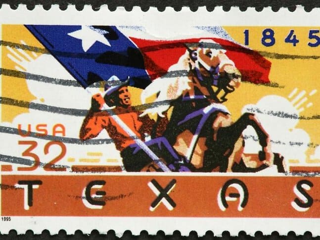 An old stamp that shows a cowboy holding a Texas flag 