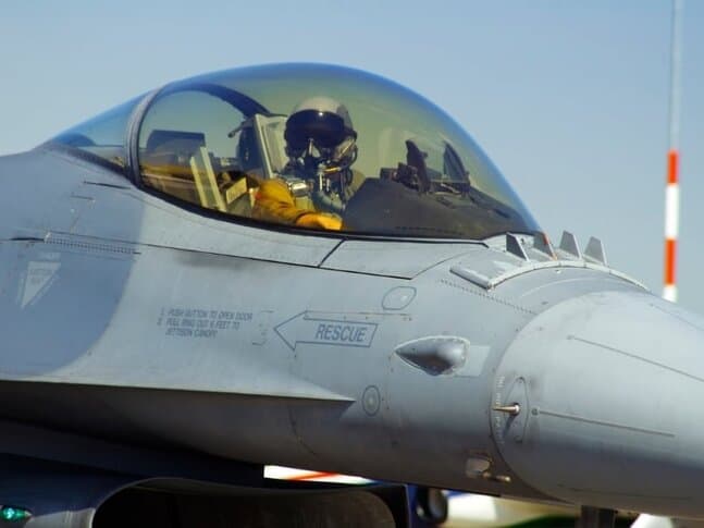 A pilot in the cockpit of a small airplane at Top Gun Flight School in Nevada