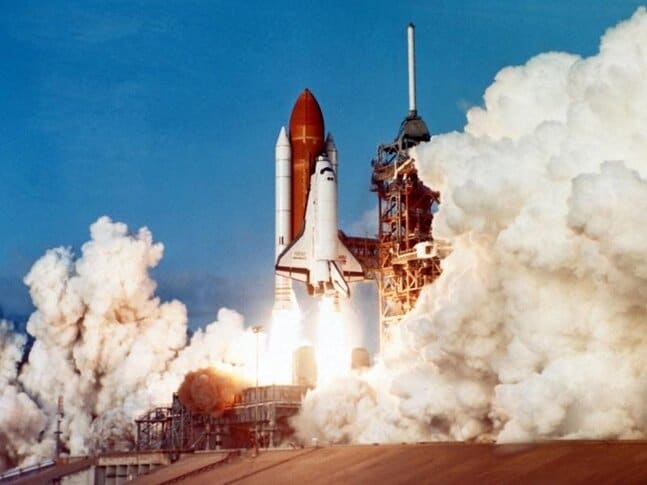 A rocket being launched with lots of exhaust in the air