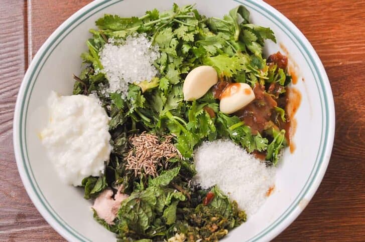 Ingredient for mint and cilantro chutney in a bowl.