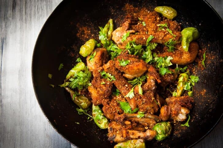 Tikka fried chiken with spices, ready to be mixed.