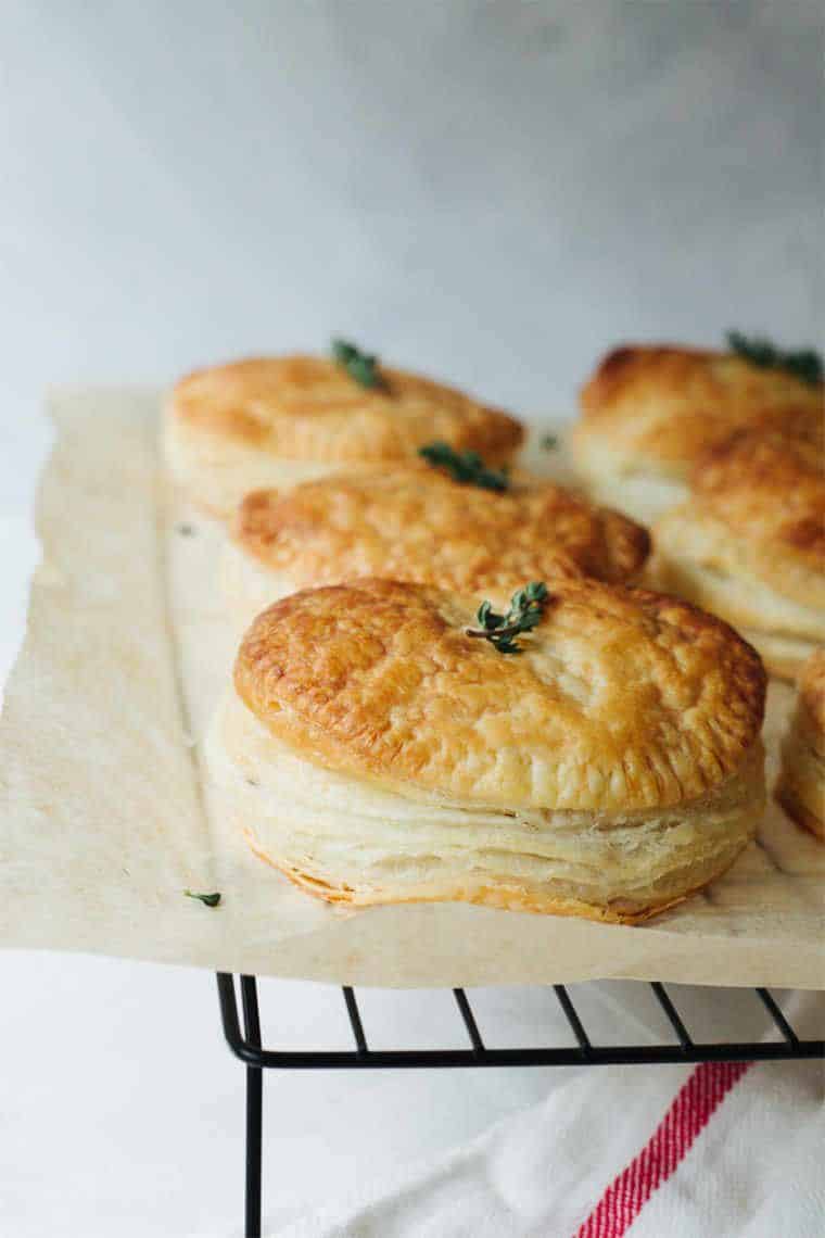 cooling rack with some parchment paper and 6 homemade lentil hand pies