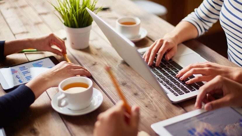 people use laptops and tablets at a table for understanding GPR systems