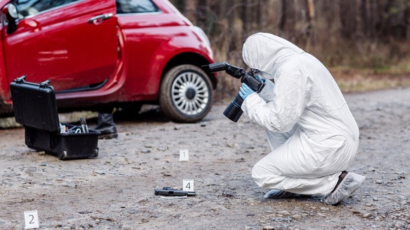 a criminologist photographs a crime scene