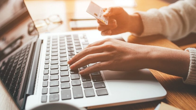 a person makes an online payment on their laptop via credit card