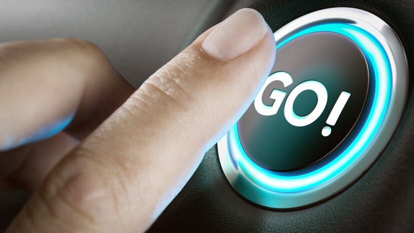 a person's finger presses a button