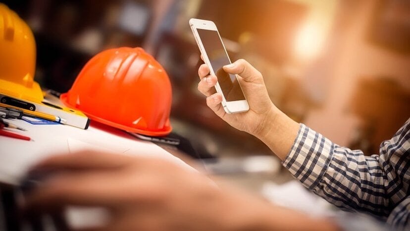 a construction worker makes a phone call