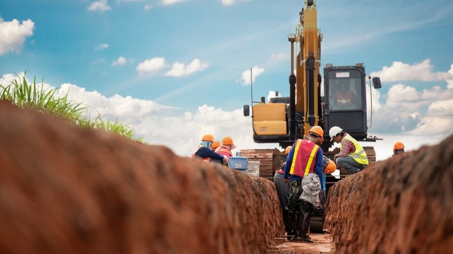 a group of construction workers during an excavation of a water drainage show what you do after planning your survey