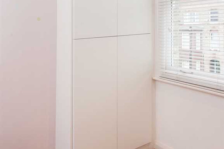 White painted alcove wardrobes with 4 slim doors and no handles