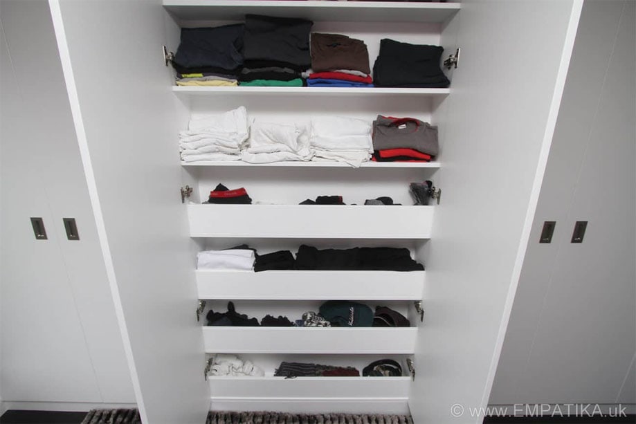 Closer view of vertical semi-open shelves inside a fitted bedroom wardrobe painted White