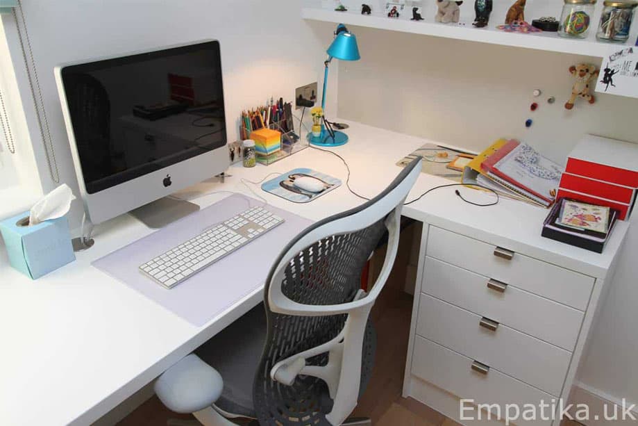 Empatika saves space by fitting an L-shaped desk into the corner of the room