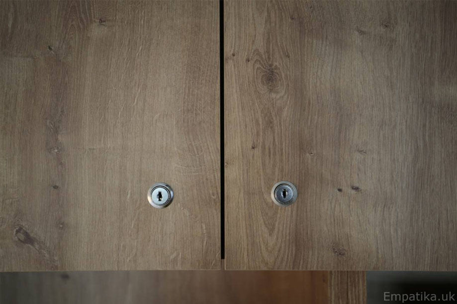 Closer view of bespoke TV media unit with lock and key cupboards