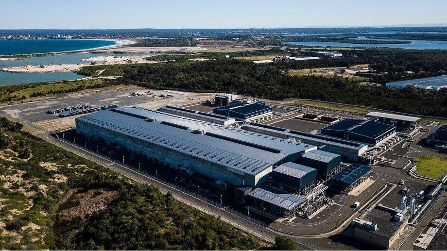 aerial shot of large building with water in background