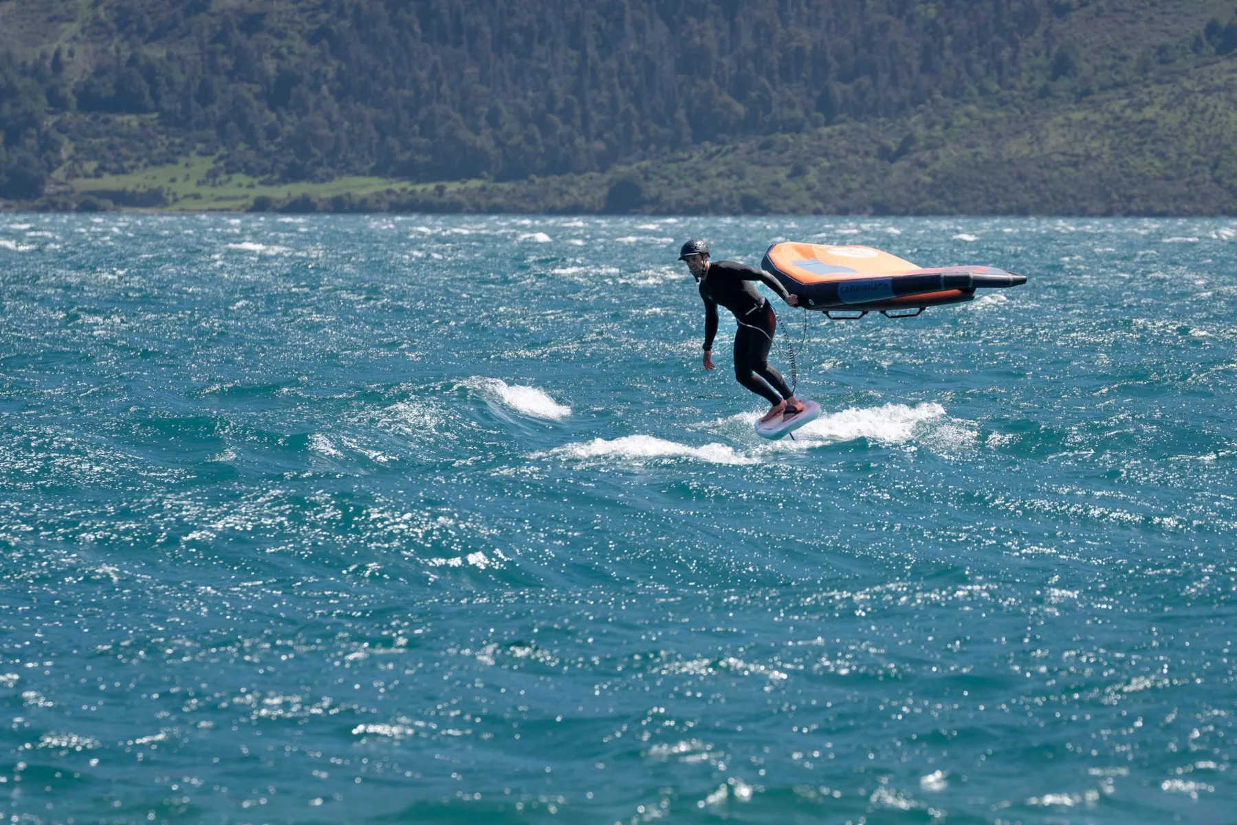 Wingfoil downwinding with flagged out wing on Lake Wakatipu