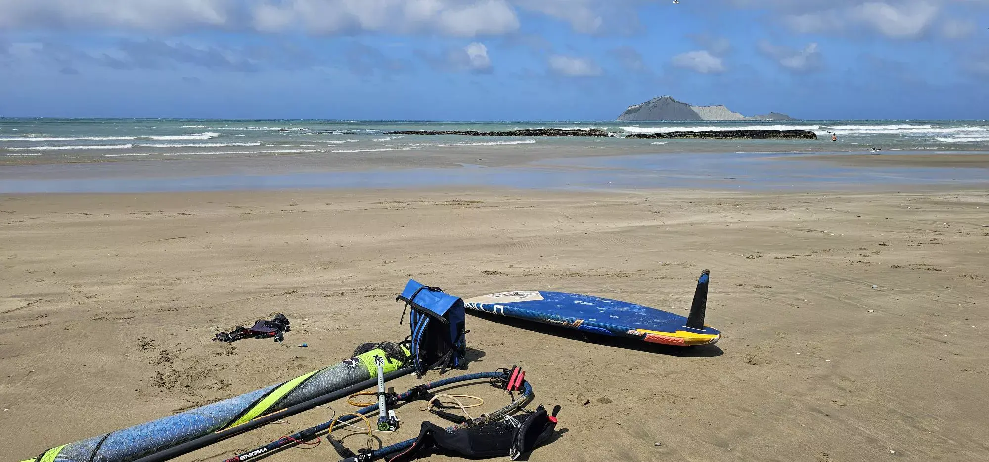 Windsurfing gear on a sandy beach in New Zealand | Windsurfing around NZ | Piers