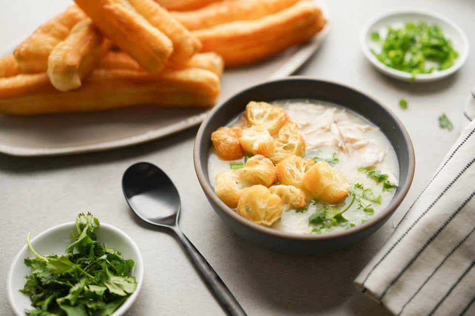 Cháo lòng with herbs and breadsticks
