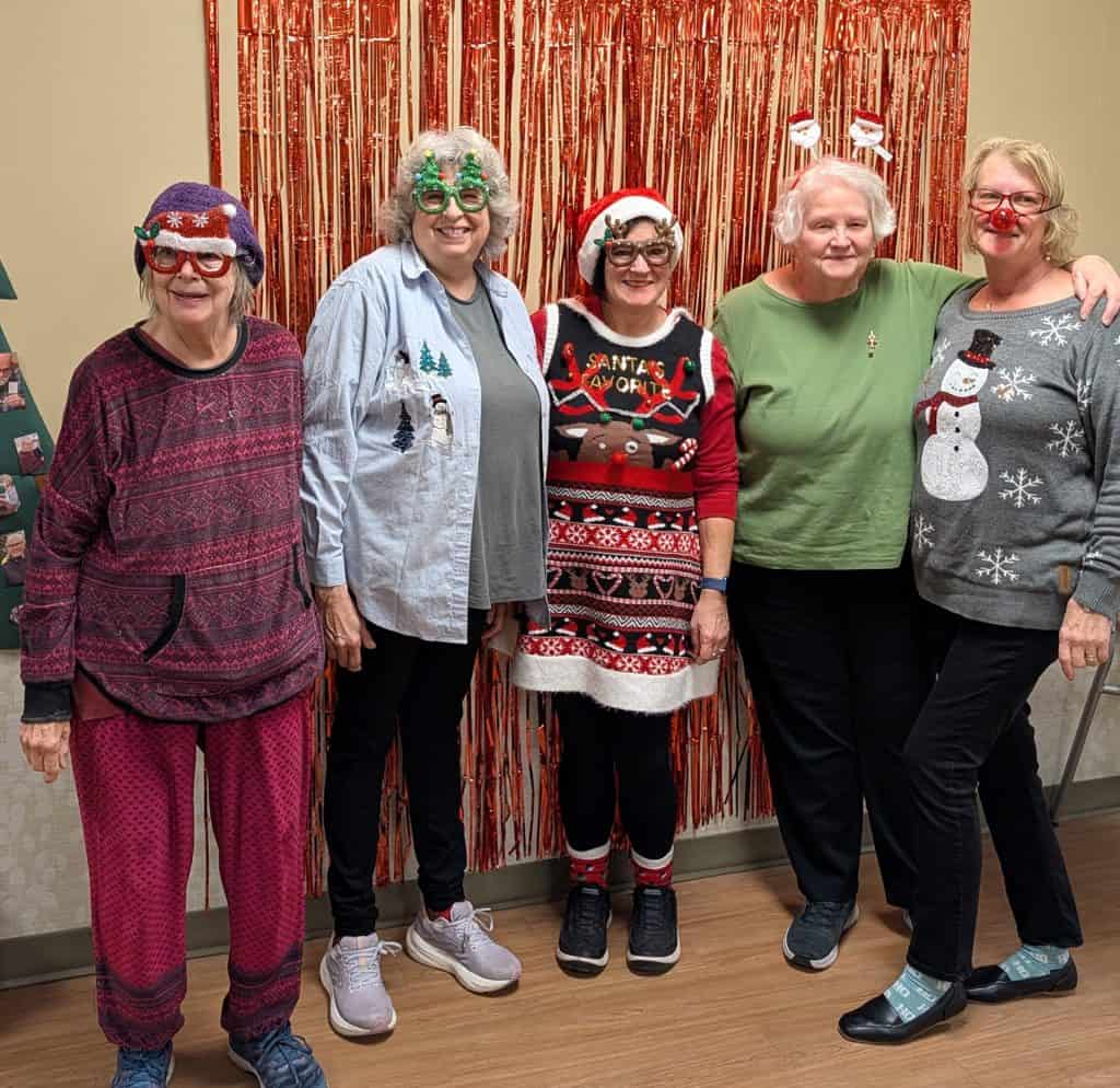 Group of women in Christmas costumes at holiday office party.