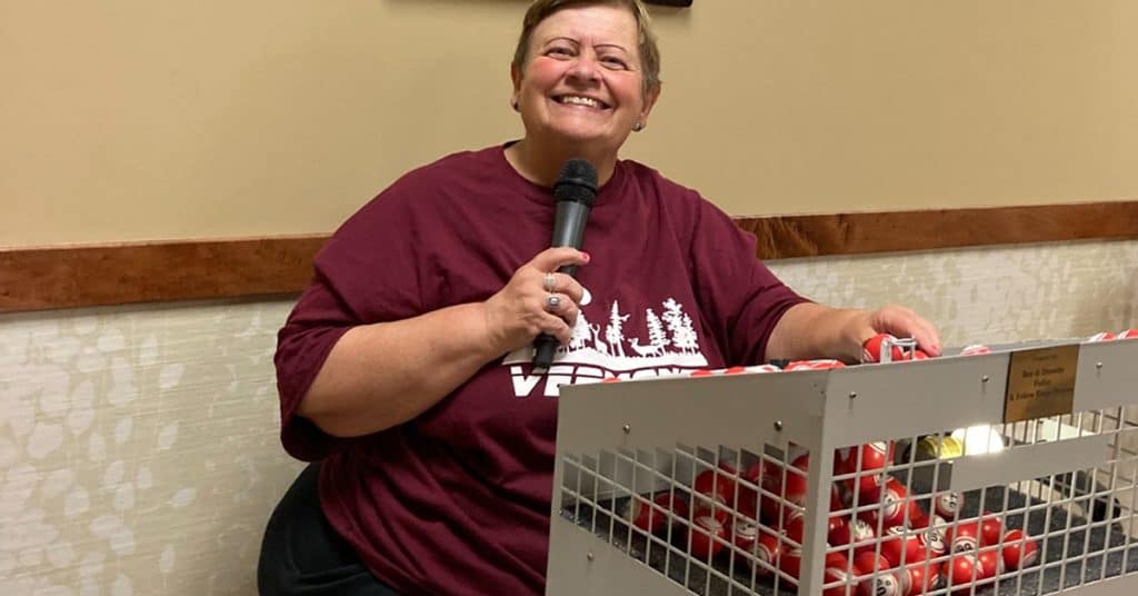 Smiling woman holding microphone at All Season Innovations event.